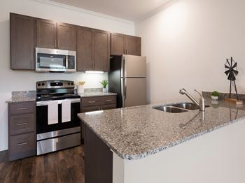Kitchen with appliances and cabinets at Ardmore at the Trail, Indian Trail